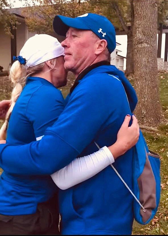 Madison gives dad a hug after winning the conference championship.